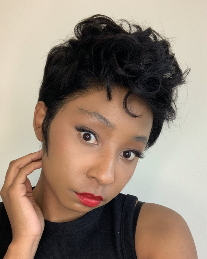 Woman with styled hair against a plain background