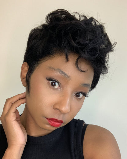 Woman with styled hair against a plain background