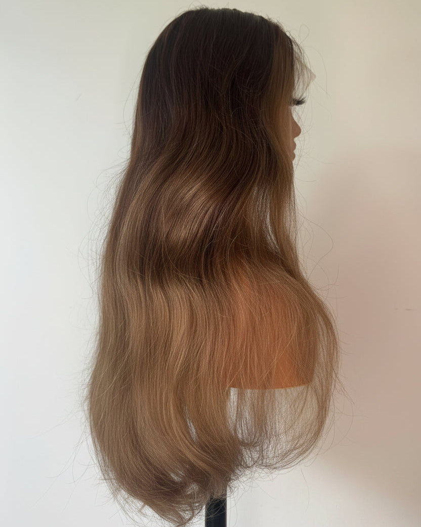 Mannequin head with long, wavy hair transitioning from dark brown to blonde on a white background.