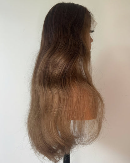 Mannequin head with long, wavy hair transitioning from dark brown to blonde on a white background.